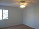 Light blue bedroom with carpeting, window, and ceiling fan at 5601 Ocean Blvd. N # 202 A, Myrtle Beach, SC 29577