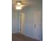 Bedroom with light blue walls, ceiling fan, and access to bathroom at 5601 Ocean Blvd. N # 202 A, Myrtle Beach, SC 29577