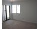 Bedroom with sliding glass doors to balcony and neutral carpeting at 5601 Ocean Blvd. N # 202 A, Myrtle Beach, SC 29577