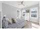 Light-filled bedroom with ceiling fan, two windows, white dresser and coastal themed decorations at Lot 40 Lineback Pl. # 40, Longs, SC 29568