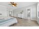 Bright bedroom with wood floors, a decorative ceiling fan, and an ensuite bathroom at Lot 40 Lineback Pl. # 40, Longs, SC 29568