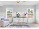 Bright living room with wainscoting, chair, console, decor, and light streaming in through the windows at Lot 40 Lineback Pl. # 40, Longs, SC 29568