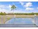 Back deck view of a pond surrounded by trees under a partially cloudy blue sky at Lot 40 Lineback Pl. # 40, Longs, SC 29568