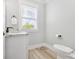 Bright half bath featuring granite countertop, undermount sink, and a window letting in natural light at Lot 42 Lineback Pl. # 42, Longs, SC 29568