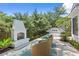 Relax in this landscaped backyard with an outdoor fireplace, hot tub, and comfortable seating at 405 N Highland Way, Myrtle Beach, SC 29572