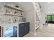 This bar area has shelving, space for glassware, and a wine fridge under the stairs at 405 N Highland Way, Myrtle Beach, SC 29572