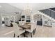 This dining room has a wooden table, chairs, and access to a fireplace, bar area and living room at 405 N Highland Way, Myrtle Beach, SC 29572