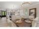 Dining area features modern chandelier, kitchen with island, and seating for six near the main entry at 405 N Highland Way, Myrtle Beach, SC 29572
