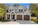 Stunning two-story white home with black shutters and a spacious two-car garage at 405 N Highland Way, Myrtle Beach, SC 29572