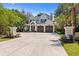 Beautifully designed white home with a wide driveway and manicured landscaping at 405 N Highland Way, Myrtle Beach, SC 29572
