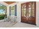 Inviting front porch with rocking chairs and a stylish double-door entry at 405 N Highland Way, Myrtle Beach, SC 29572