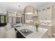 Bright kitchen featuring a marble island, modern appliances, and woven pendant lights at 405 N Highland Way, Myrtle Beach, SC 29572