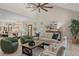 This living room features neutral furniture, a high ceiling, and open access to the dining area and kitchen at 405 N Highland Way, Myrtle Beach, SC 29572