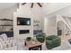This living room has neutral furniture, fireplace, a high ceiling, and open access to the dining and bar areas at 405 N Highland Way, Myrtle Beach, SC 29572