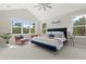 Airy main bedroom with many windows, a trey ceiling, and stylish furniture at 405 N Highland Way, Myrtle Beach, SC 29572