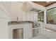 Outdoor kitchen with granite counters, stainless steel appliances, and wood ceiling detail at 405 N Highland Way, Myrtle Beach, SC 29572