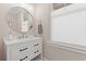 Well-lit powder room with a modern vanity, round mirror, and updated fixtures at 405 N Highland Way, Myrtle Beach, SC 29572