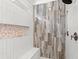 Modern walk-in shower featuring unique tilework, a built-in bench, and a rainfall showerhead fixture at 405 N Highland Way, Myrtle Beach, SC 29572