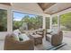 Sunroom features ample seating and views of the landscaped backyard with an outdoor fireplace at 405 N Highland Way, Myrtle Beach, SC 29572