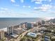An aerial view showcasing the coastline and building, close to the beach, under a picturesque sky at 7200 Ocean Blvd. N # 254, Myrtle Beach, SC 29572