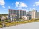 The aerial showcases condo buildings near the beach, featuring a pool. Palm trees add to the scenic beachfront setting at 7200 Ocean Blvd. N # 254, Myrtle Beach, SC 29572