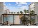 Enjoy scenic views of the ocean, pool, and surrounding buildings from this cozy condo balcony at 7200 Ocean Blvd. N # 254, Myrtle Beach, SC 29572