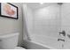Contemporary bathroom featuring a white-tiled shower-tub and modern fixtures at 7200 Ocean Blvd. N # 254, Myrtle Beach, SC 29572