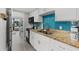 Efficient kitchen with stainless steel sink, white cabinetry, and blue backsplash at 7200 Ocean Blvd. N # 254, Myrtle Beach, SC 29572