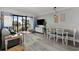 Bright living room boasts a dining area, balcony access, and a TV for relaxation and entertaining at 7200 Ocean Blvd. N # 254, Myrtle Beach, SC 29572