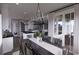 Elegant dining area with a long table, chandelier, and view of the kitchen and patio at 409 N Highland Way, Myrtle Beach, SC 29572