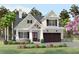 Charming two-story home featuring a covered porch with stone accents and a two-car garage at 409 N Highland Way, Myrtle Beach, SC 29572