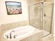 Elegant bathroom featuring a soaking tub and a separate glass-enclosed shower with beige tile at 516 Papyrus Circle # 516, Little River, SC 29566