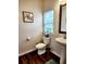 Bathroom with pedestal sink, decorative mirror, tile floors, and a window at 516 Papyrus Circle # 516, Little River, SC 29566