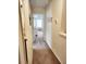 Hallway leading to a bedroom with a view of a window, a bed, and a dresser at 516 Papyrus Circle # 516, Little River, SC 29566