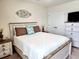 Comfortable bedroom featuring a ceiling fan, light colored decor, and beach themed throw pillows at 516 Papyrus Circle # 516, Little River, SC 29566