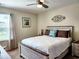 Comfortable bedroom featuring a ceiling fan, a window with curtains, and beach themed décor at 516 Papyrus Circle # 516, Little River, SC 29566