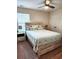 Cozy bedroom with a queen bed, a ceiling fan, and large windows at 516 Papyrus Circle # 516, Little River, SC 29566