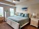 Bedroom features include beach decor, a ceiling fan, natural lighting, and carpeted floors at 516 Papyrus Circle # 516, Little River, SC 29566