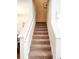 Carpeted stairway with a white railing leads to the upper level of the home at 516 Papyrus Circle # 516, Little River, SC 29566
