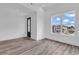 Bedroom boasting a large window with a view, wood-look flooring, and modern trim at 835 Waterton Ave., Myrtle Beach, SC 29579