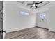 Bedroom with wood-look floors, recessed lighting, tray ceiling with fan, and large windows at 835 Waterton Ave., Myrtle Beach, SC 29579