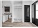 Stylish entryway with black door, custom built-in shelves and wood plank flooring at 835 Waterton Ave., Myrtle Beach, SC 29579