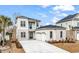 Stunning two-story home with stone accents, a black roof, a paved drive and a three-car garage at 835 Waterton Ave., Myrtle Beach, SC 29579