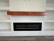 Modern electric fireplace with wood mantel and shelves at 835 Waterton Ave., Myrtle Beach, SC 29579