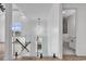Foyer with wood floors, shiplap accent wall, glass railing, and a view of a modern chandelier at 835 Waterton Ave., Myrtle Beach, SC 29579