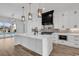 Modern kitchen featuring a waterfall island, stainless appliances, and black accents with wood plank flooring at 835 Waterton Ave., Myrtle Beach, SC 29579