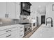 Modern kitchen featuring white cabinets, gray backsplash, stainless steel appliances, and marble countertops at 835 Waterton Ave., Myrtle Beach, SC 29579