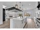 Open kitchen with island overlooking the living area, fireplace, and pool view at 835 Waterton Ave., Myrtle Beach, SC 29579