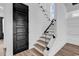 Staircase featuring modern design with glass railings and black accents, leading to upper level at 835 Waterton Ave., Myrtle Beach, SC 29579