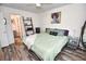 Comfortable bedroom with wood floors and decor; ensuite bathroom at 9550 Dunes Gable Dr. # F, Myrtle Beach, SC 29572